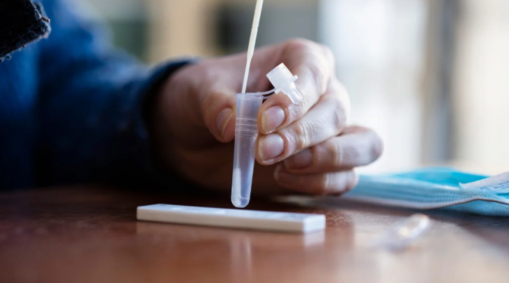 A man tests himself for COVID